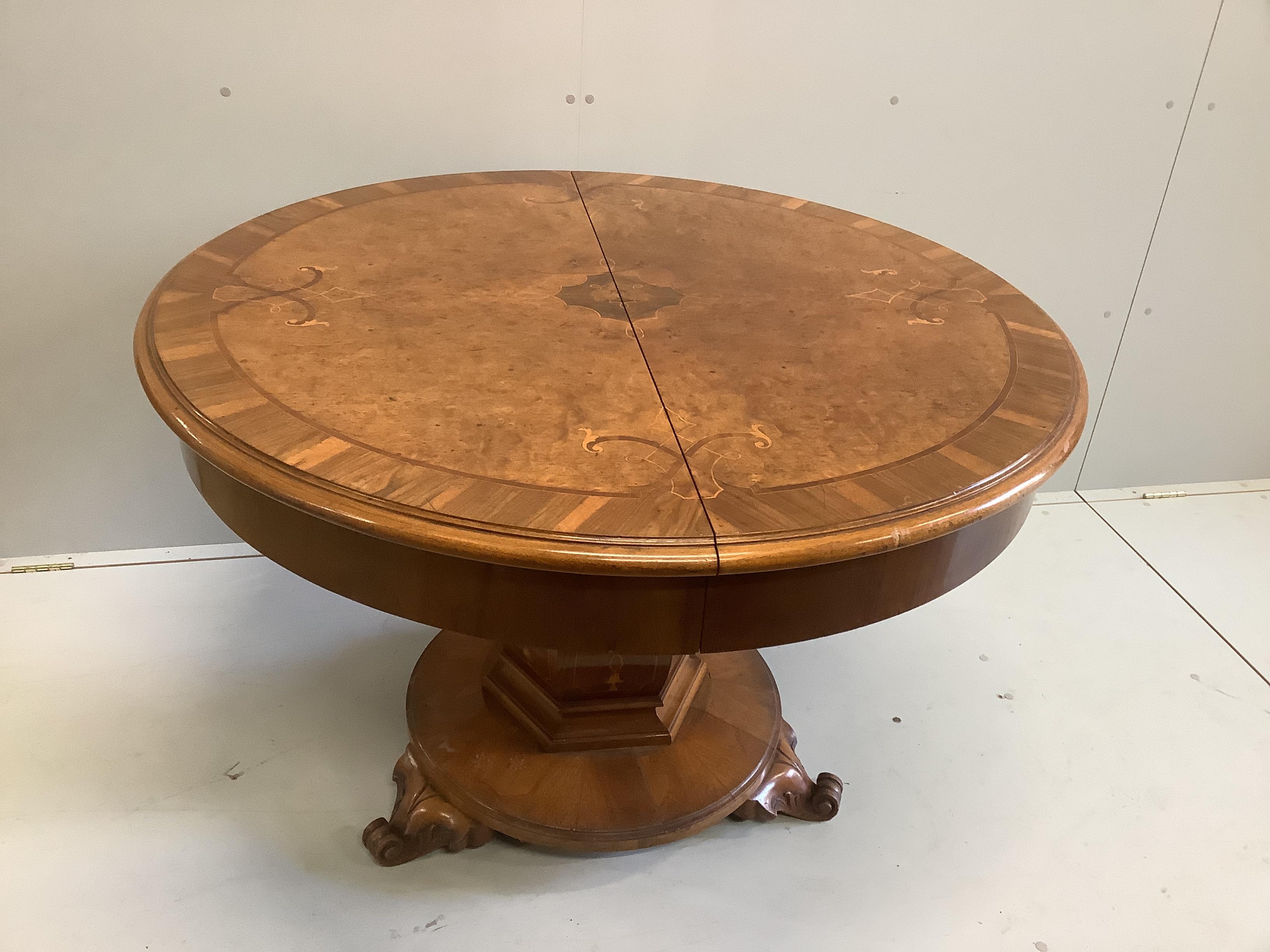 An Austrian marquetry inlaid circular walnut dining table, diameter 114cm, height 79cm, together with eight upholstered dining chairs on cabriole legs